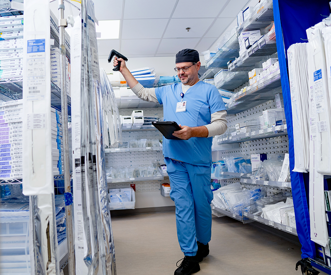 Supply Chain Coordinator scanning medications.