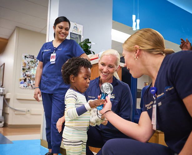 Nurses interact with child.
