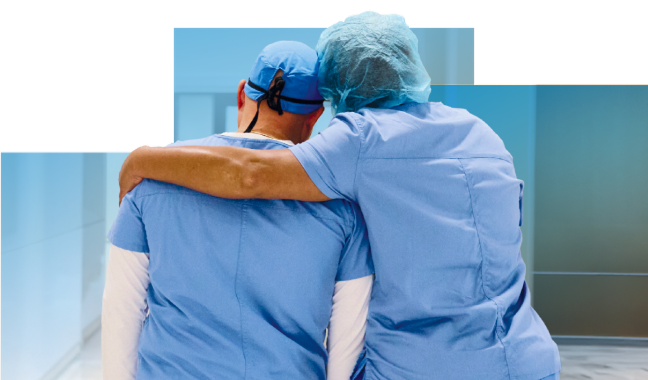 Support shown between two colleagues as one puts their arm around the shoulders of the other